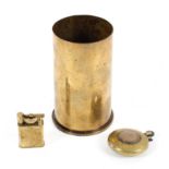 Two trench art lighters together with a brass shell case,