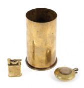 Two trench art lighters together with a brass shell case,