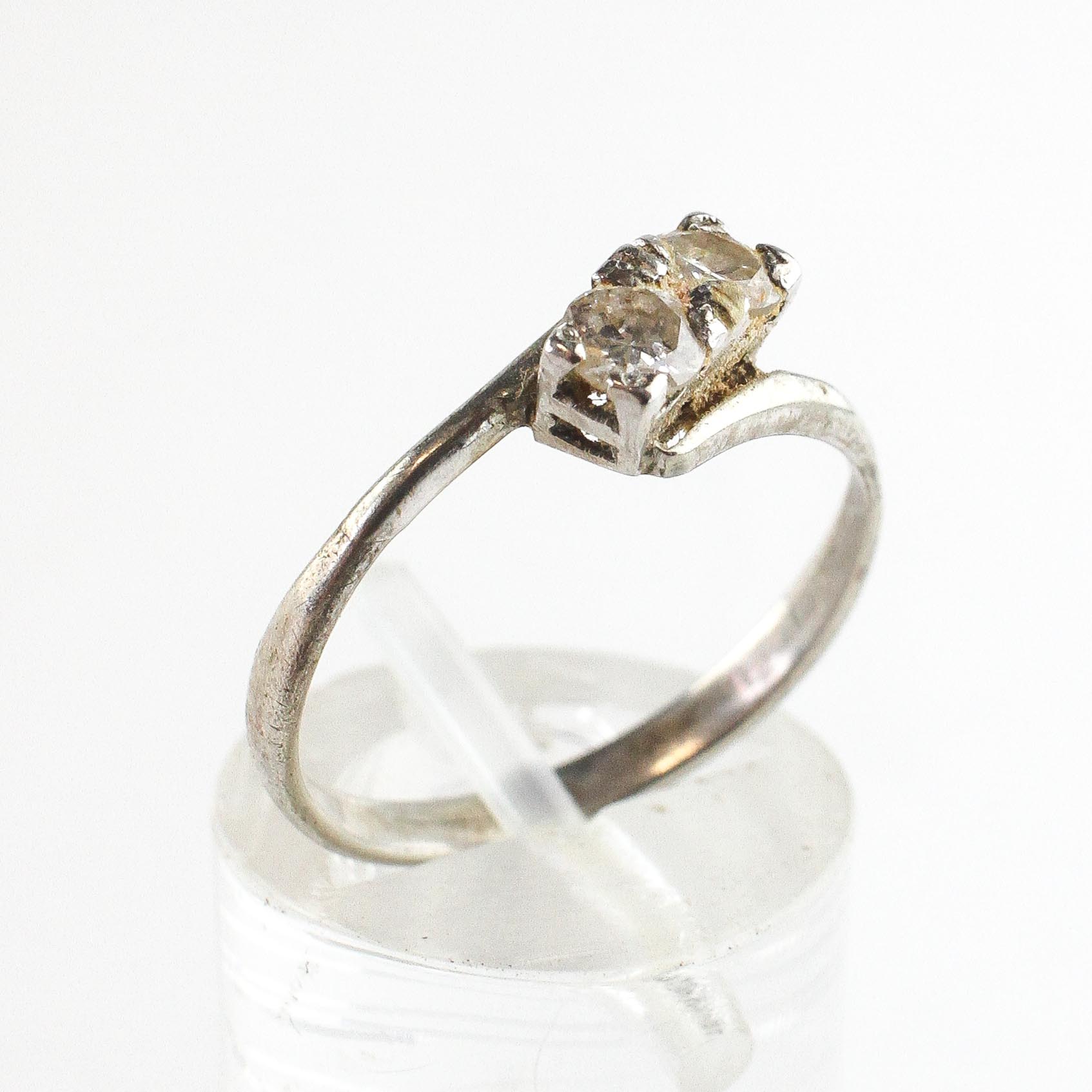 A white metal crossover ring.