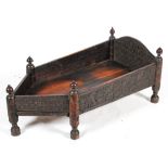 An Indian carved hardwood cot, of pointed rectangular form,