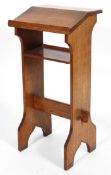 A Victorian oak bible rest, with slop above shelf on twin supports,