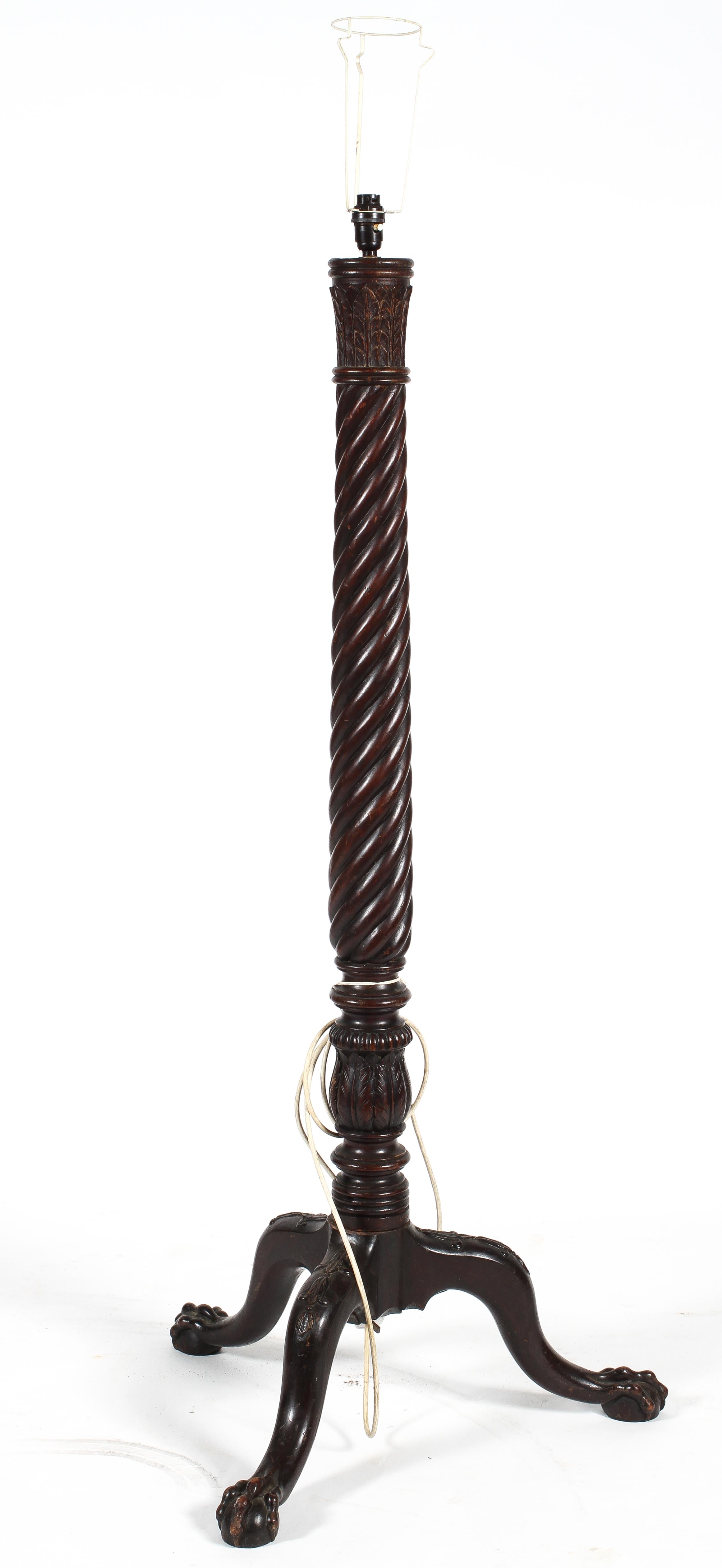 A mahogany 'bed post' standard lamp with tripod base,