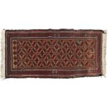 A Middle Eastern wool rug, 20th century, with brown, red and pink geometric ornament,