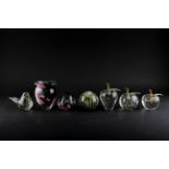 A collection of glass paperweights, including four with bubble inclusions, two formed as fruit,