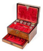 A Victorian rosewood and brass mounted vanity box, the hinged cover revealing a interior,