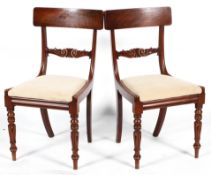 A pair of Regency style mahogany dining chairs with bar backs, drop in seats and turned front legs,