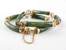 A pair of bracelets of identical design having cylindrical links in the style of nephrite jade