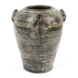 A black glazed terracotta tapering urn, with upright loop handles, reeded body,