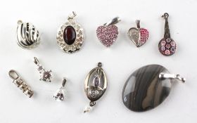 A collection of ten silver pendants of variable designs. Most are stamped 925 for sterling silver.