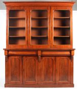 A large Victorian mahogany bookcase, with three glazed doors enclosing three shelves,