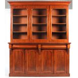 A large Victorian mahogany bookcase, with three glazed doors enclosing three shelves,