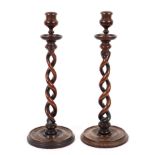 A pair of barley twist mahogany candlesticks, with baluster turned sconces,