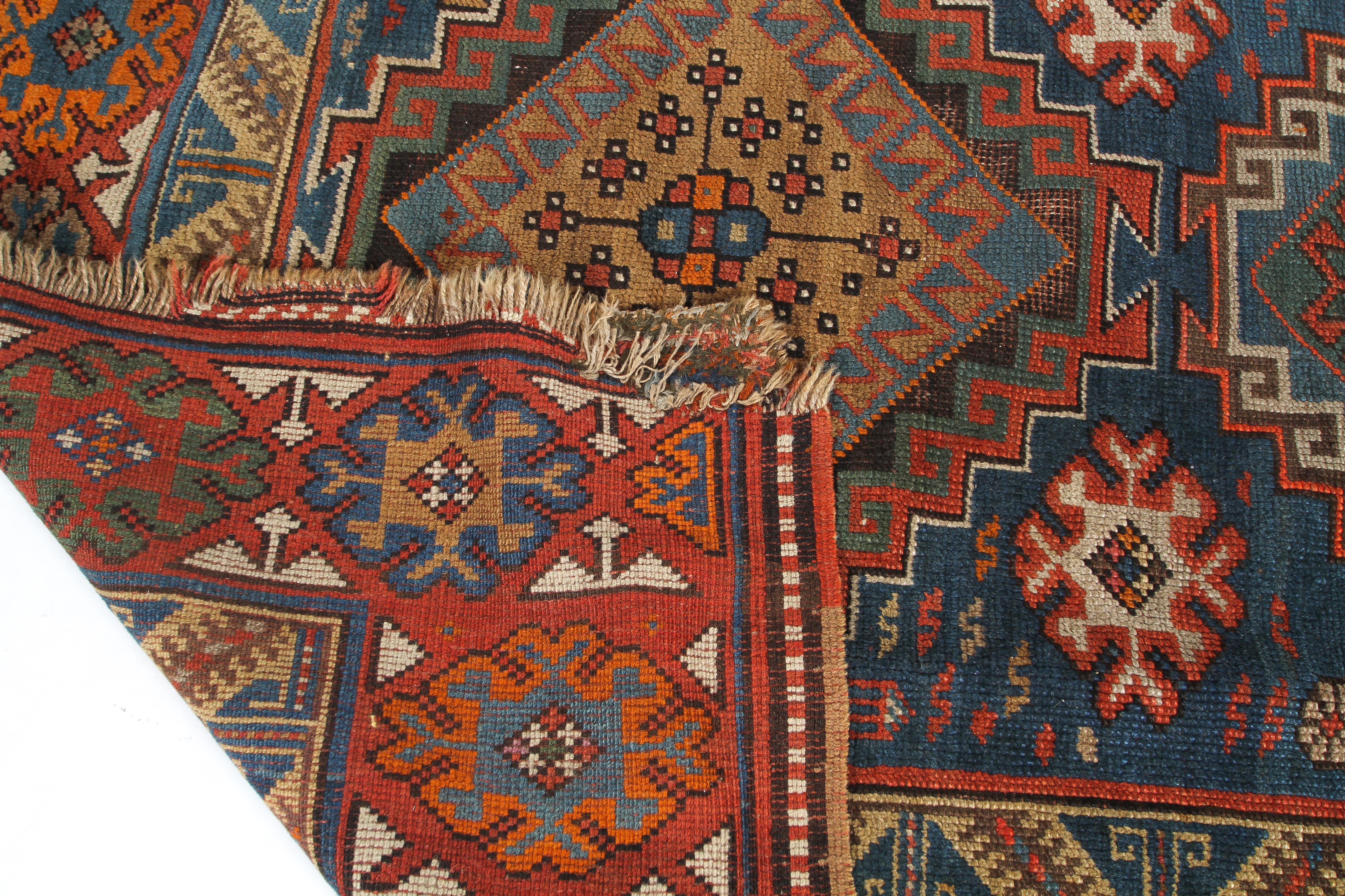 A 20th century Kazak style wool rug, woven with geometric lozenges on a blue ground with red border, - Image 3 of 13