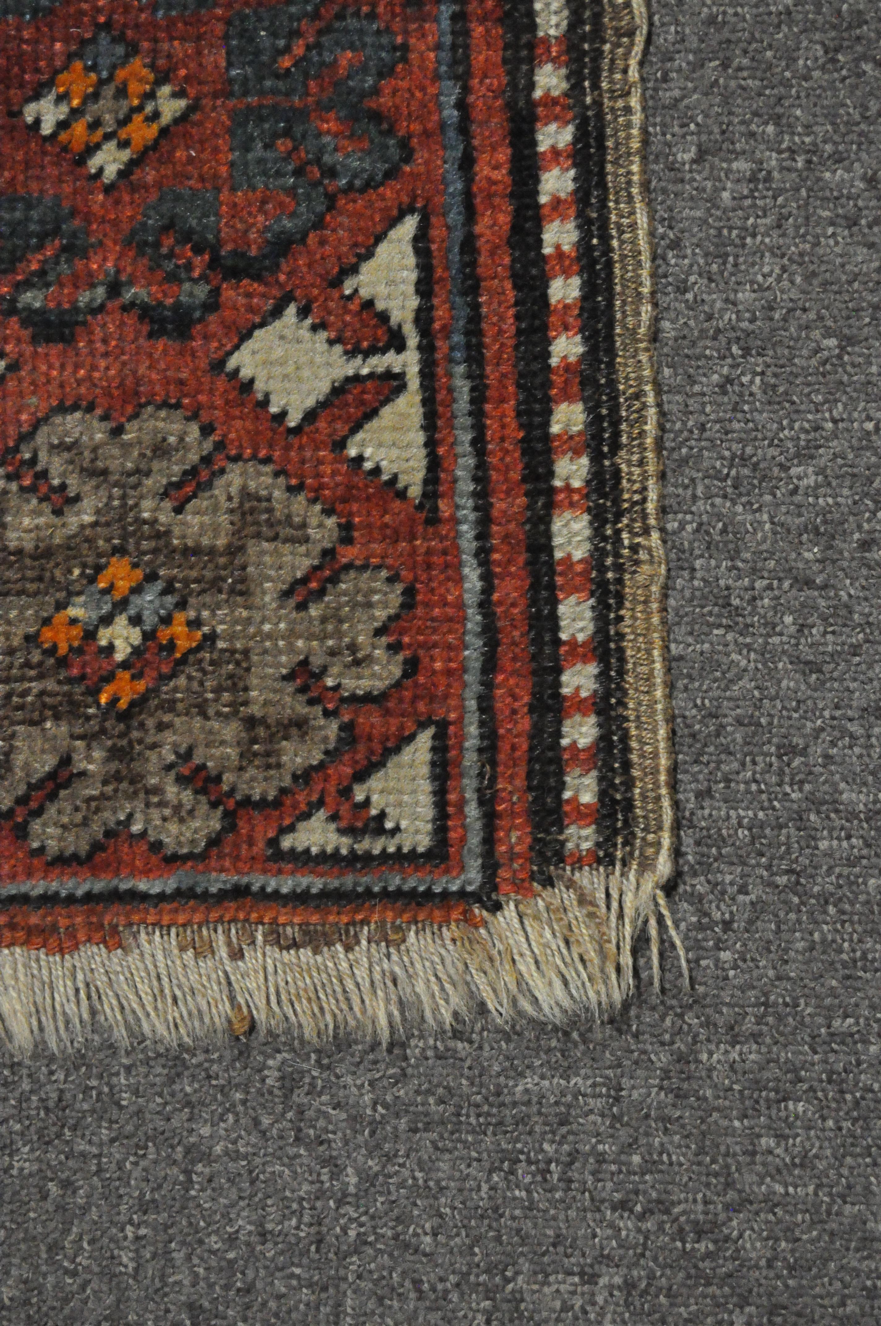 A 20th century Kazak style wool rug, woven with geometric lozenges on a blue ground with red border, - Image 7 of 13