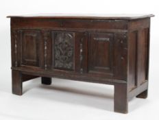 An oak coffer, with hinged plank top,