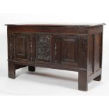 An oak coffer, with hinged plank top,