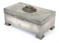 An Arts & Crafts pewter cigar box, inset with turquoise and beeded ornament to hinged lid,