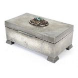 An Arts & Crafts pewter cigar box, inset with turquoise and beeded ornament to hinged lid,