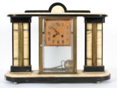 An art deco style clock garniture in alabaster and black slate or marble,