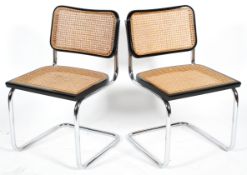 After Marcel Breuer, a pair of cantilever chairs with tubular chrome frame, caned seat and back,
