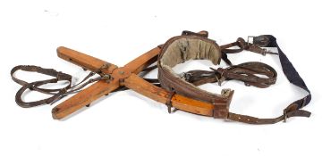 An Edwardian dumb jockey, with articulated wooden x-frame with leather mounts and straps,