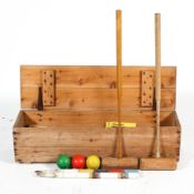 A croquet set by Jaques, including mallets, balls and stakes, in pine box,