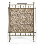 A Victorian brass fire screen, with spindle frame, mounted with tapestry style fabric,