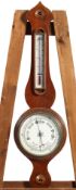 A mahogany wheel barometer with ivorine thermometer gauge and main dial,