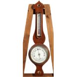 A mahogany wheel barometer with ivorine thermometer gauge and main dial,