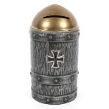 A novelty, trench art style tin money box, in the form of a shell with a German Cross to the front,