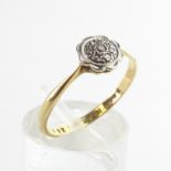 A yellow and white metal diamond flower cluster ring. Stamped 18ct Plat. Size N
