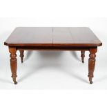 A Victorian mahogany extending dining table, with two additional leaves and handle,