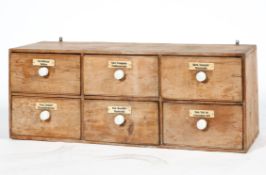 An early 20th century pine six drawer kitchen or medicine chest,