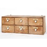 An early 20th century pine six drawer kitchen or medicine chest,