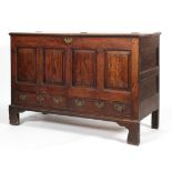 A Georgian oak mule chest, with hinged top, panelled front above two drawers, on ogee feet,