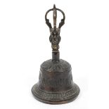 A bronze bell with Asian deity forming handle, the bell cast with swags,