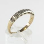 A yellow and white metal half hoop ring.