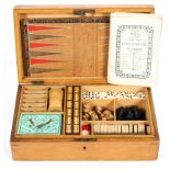 A Victorian boxed compendium of games, including two leather boards, pieces for chess, bezique,