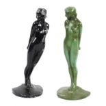 A pair of Art Deco metal book ends cast as naked ladies holding balls behind them,