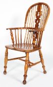 An oak and yew Windsor chair, with pierced scroll splat and baluster arm supports,