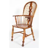 An oak and yew Windsor chair, with pierced scroll splat and baluster arm supports,