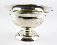 An Edwardian silver bowl raised on footed base, with flowing border,