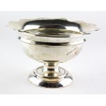 An Edwardian silver bowl raised on footed base, with flowing border,