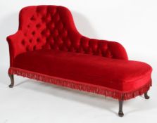An Edwardian red velvet button-back chaise lounge, on cabriole legs, with red fringing,