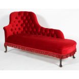 An Edwardian red velvet button-back chaise lounge, on cabriole legs, with red fringing,