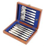 A canteen of six silver-plated fish knives and forks with mother of pearl handles,