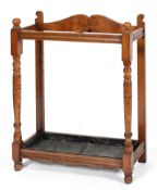 A Victorian oak umbrella/stick stand, with turned baluster uprights,