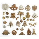 A collection of vintage cap badges and military brass buttons, including WWI examples,