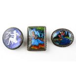 A collection of three brooches each depicting portraits.