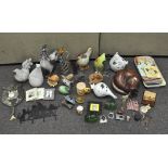 An assortment of cat and chicken related collectables,